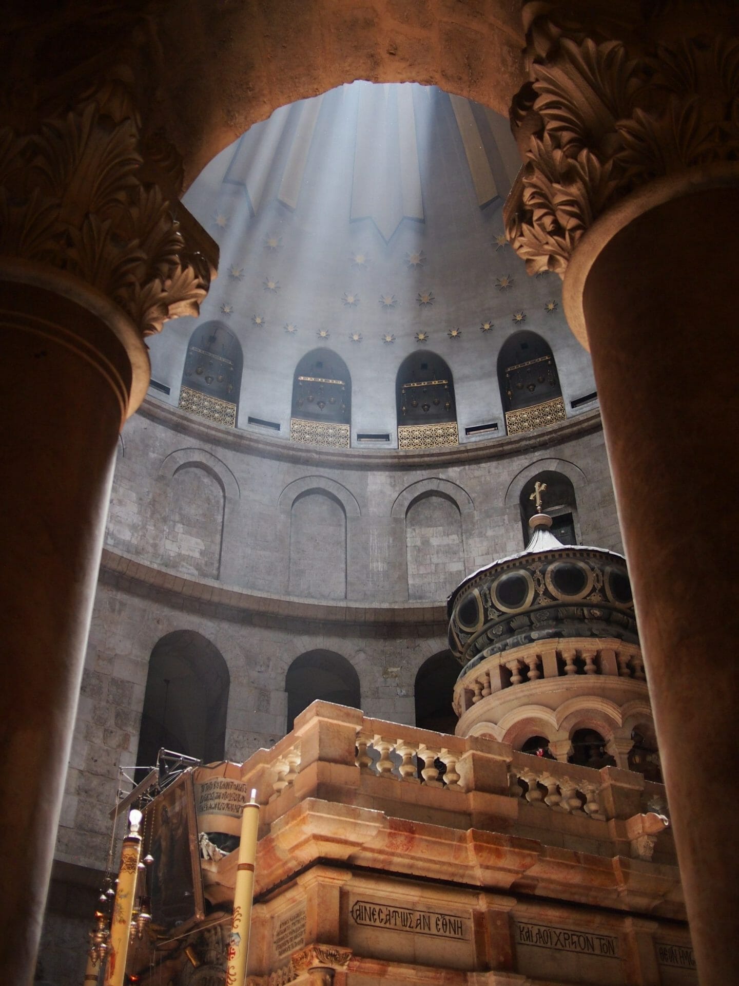 Jerusalem, Israel - 02 June, 2017: Beams of light pierce through the open ceiling inside the Church, illuminating the tomb where Jesus is said to be buried.