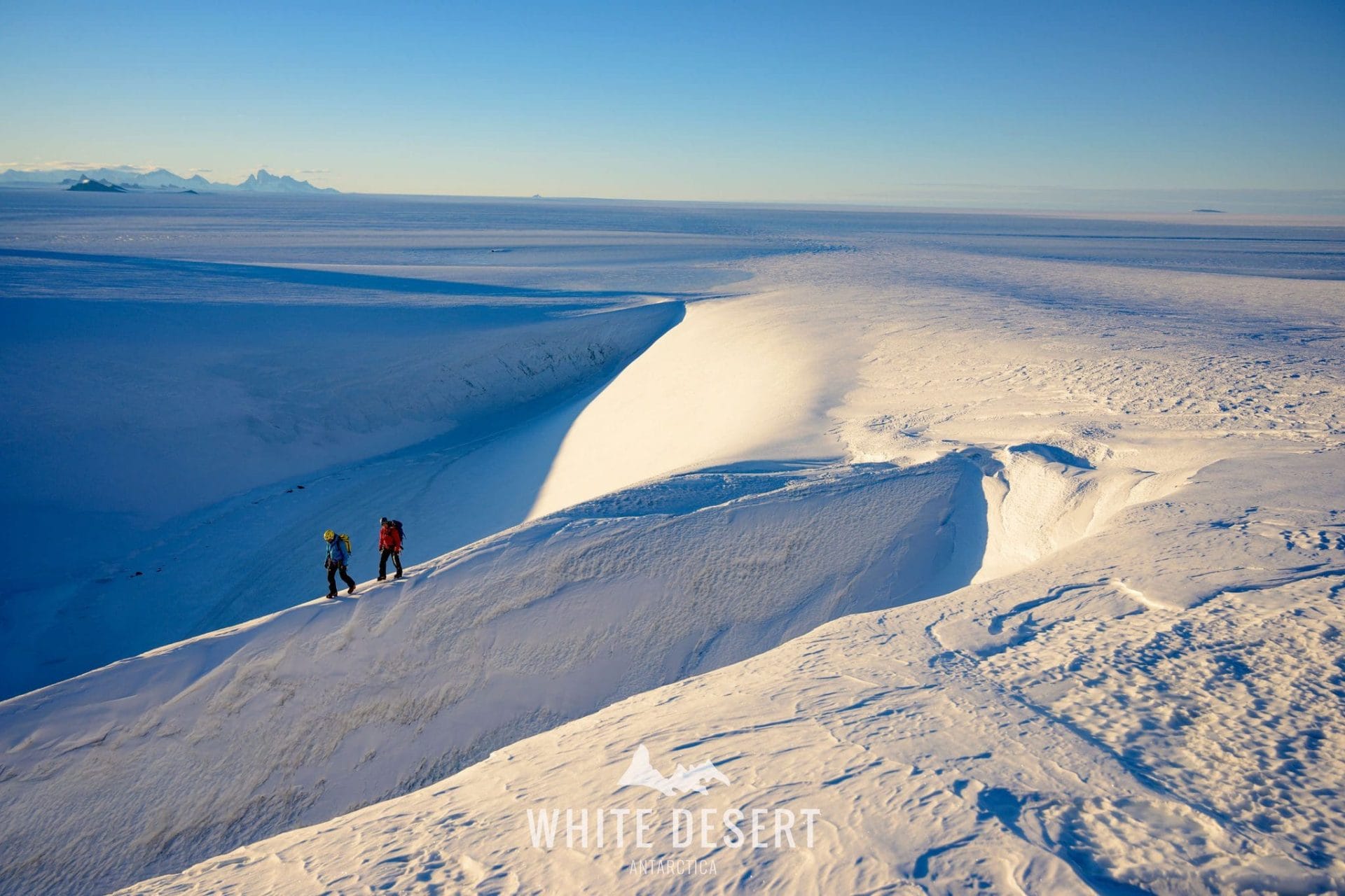 Two mountaineers walking in Antarctica
