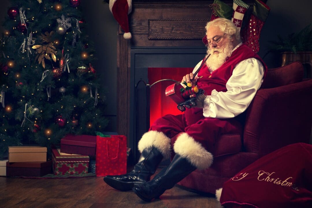 Santa Claus sitting with a toy