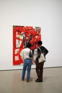 Man and woman looking at a red painting