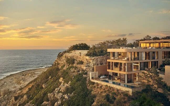 Panoramic view of hotel over cliff at sunset